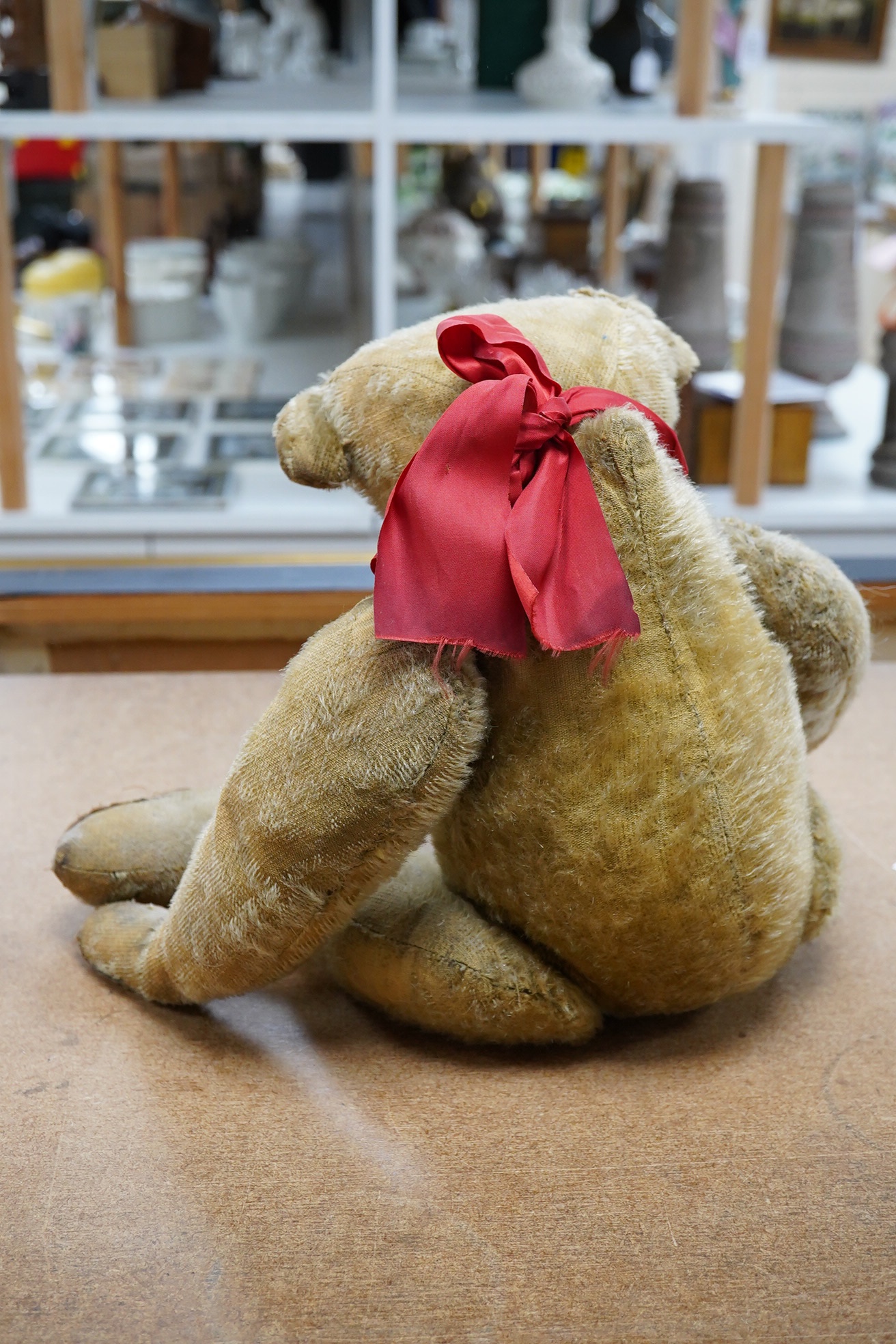 An early German bear wearing medal commemorating Queen Victoria's Jubilee, hair loss and general wear and staining to mohair, c.1912, 48cm high